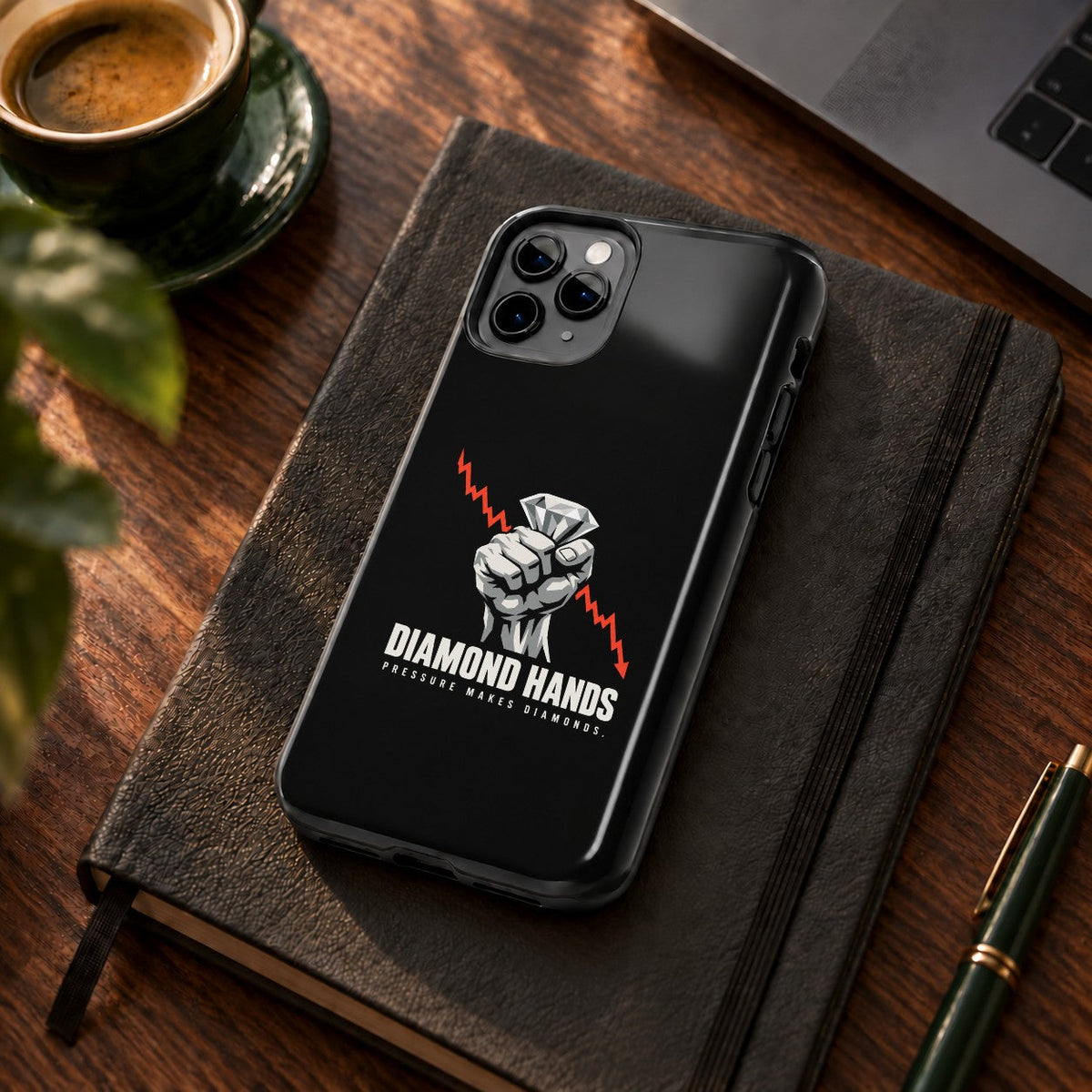 Diamond Hands phone case on a desk with coffee and a notebook