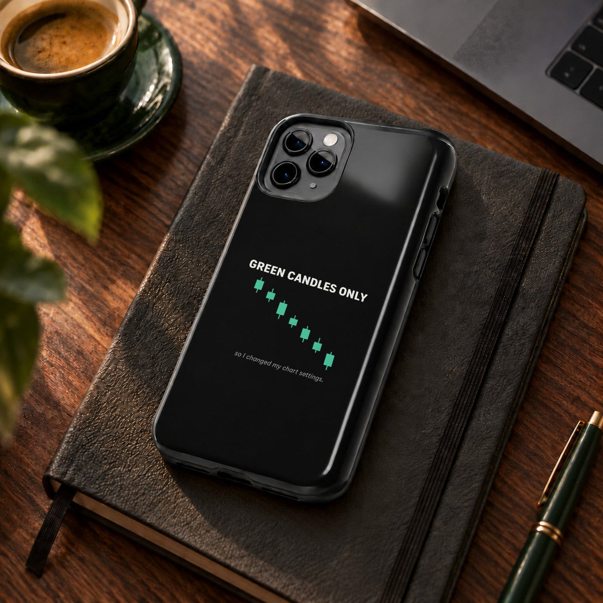 Green Candles Only phone case on a desk with coffee and a notebook