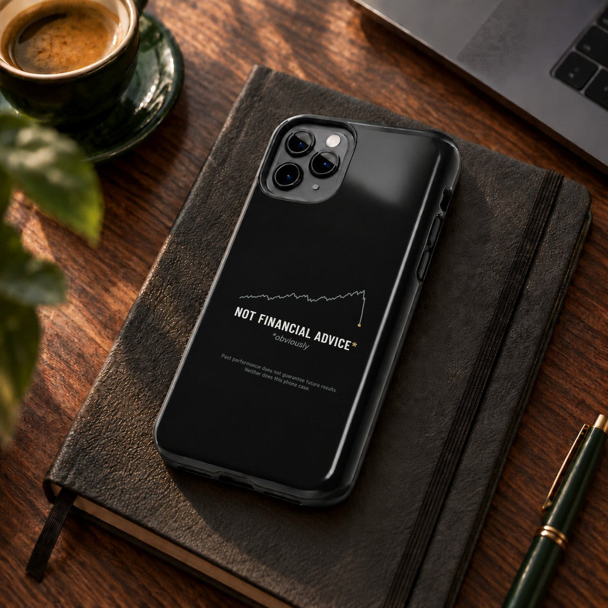 Not Financial Advice phone case on a desk with coffee and a notebook